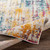multicolour abstract rug folded on wood floor