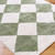 green diamond shaggy rug closeup corner on wood floor