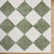 green diamond shaggy rug closeup corner on wood floor