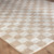beige checker shaggy rug closeup corner on wood floor