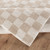 beige checker shaggy rug folded on wood floor