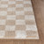 beige checker shaggy rug closeup corner on wood floor