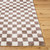 brown checker shaggy rug closeup corner on wood floor