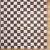 brown checker shaggy rug closeup corner on wood floor
