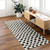 ivory black scandi rug in a room with matching decor