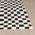 ivory black scandi rug closeup corner on wood floor