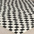 ivory black scandi rug closeup corner on wood floor