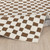 ivory brown scandi rug folded on wood floor