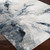 blue abstract rug closeup corner on wood floor