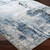 blue abstract rug closeup corner on wood floor