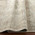 sage traditional rug folded on wood floor