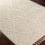 beige berber geometric rug closeup corner on wood floor