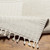 ivory berber geometric rug corner fold on wood floor