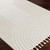 ivory berber geometric rug closeup corner on wood floor