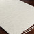 ivory berber geometric rug closeup corner on wood floor