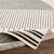 mono geometric rug corner fold on wood floor