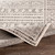 grey geometric rug corner fold on wood floor