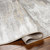 grey abstract rug corner fold on wood floor