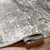 grey abstract rug corner fold on wood floor