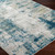 teal abstract rug closeup corner on wood floor