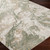 green abstract rug closeup corner on wood floor