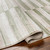 green abstract rug corner fold on wood floor