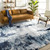 navy abstract rug in a room with matching decor