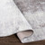 cream abstract rug corner fold on wood floor