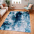 teal abstract rug in a room with matching decor