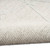 grey ivory calvin klein rug partially rolled on white floor