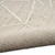 taupe calvin klein rug partially rolled on white floor