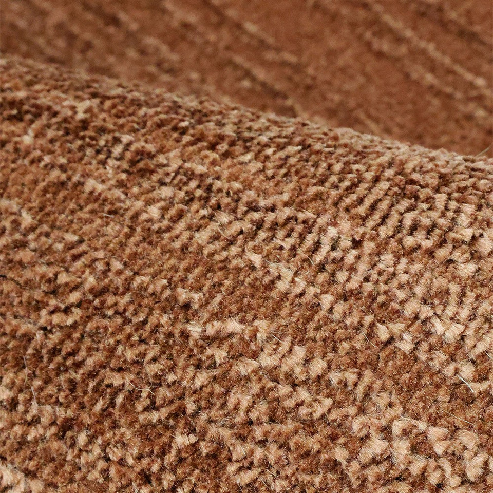 Arlo Textured Terracotta Rug in a living space with a seating arrangement.