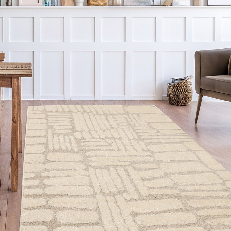 Ava Pave Cream Rug in a living room