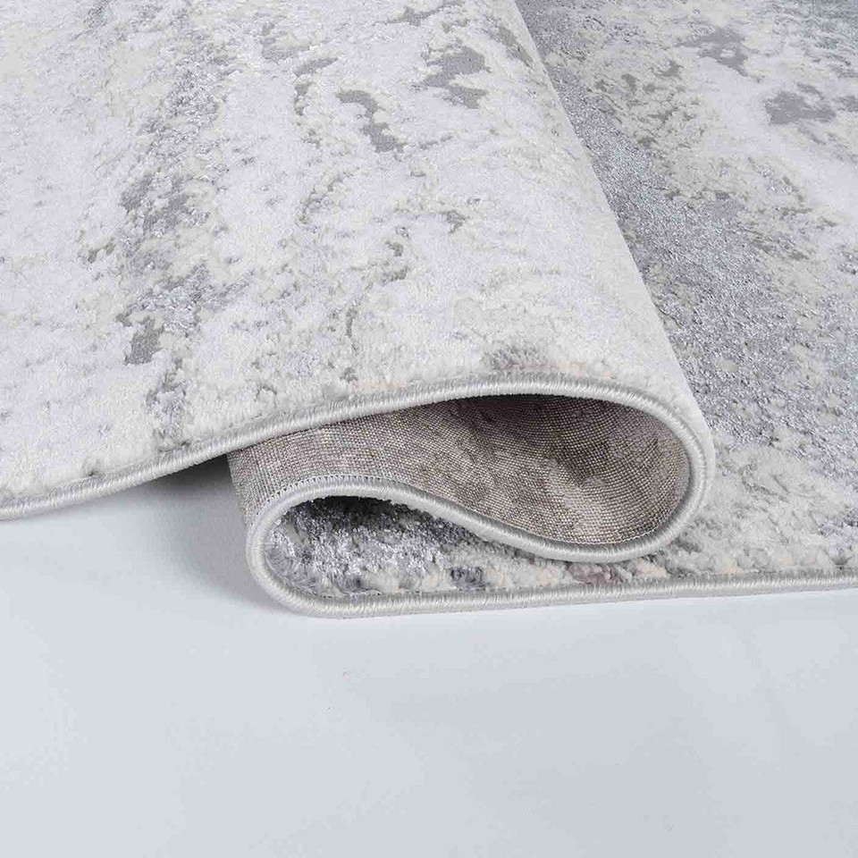 silver grey abstract rug runner folded white floor