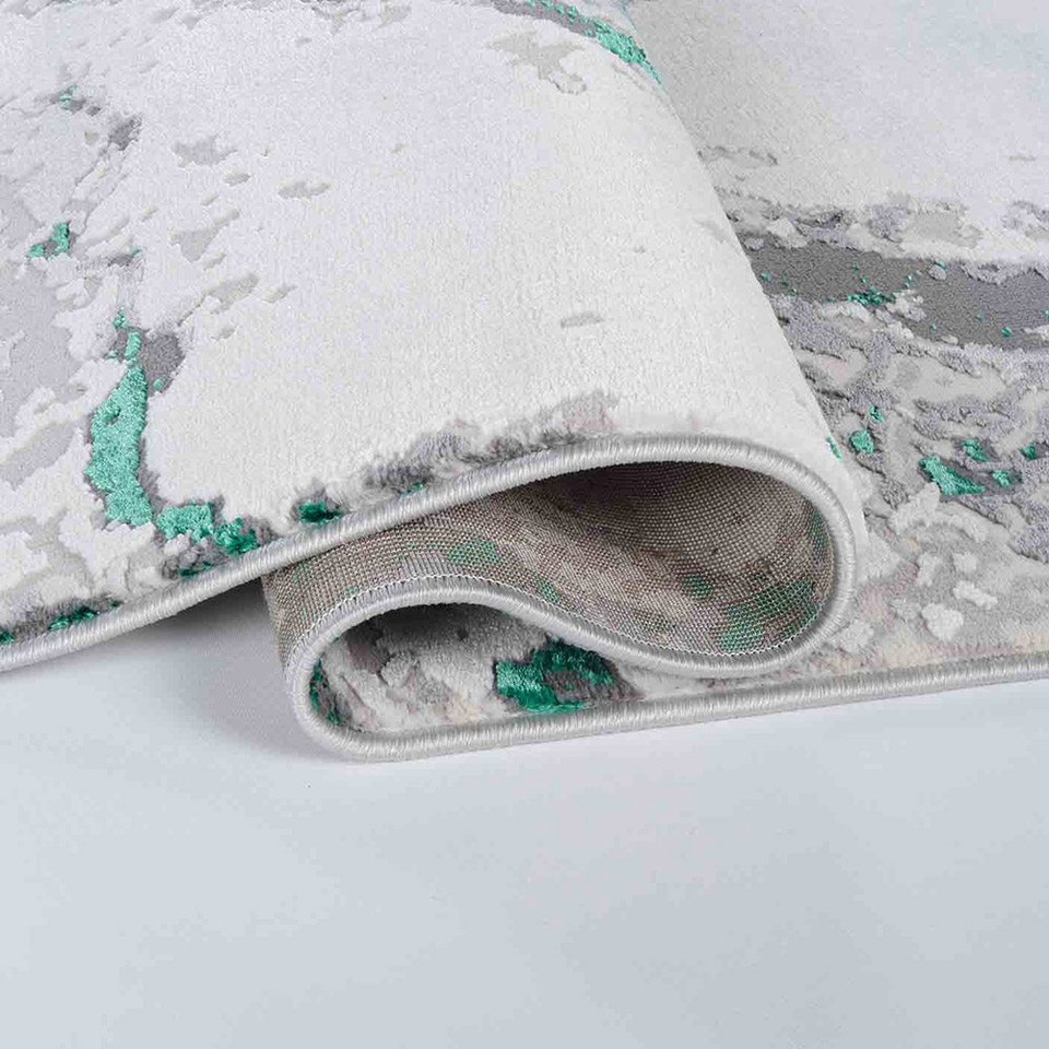 aqua grey abstract rug runner folded on white floor