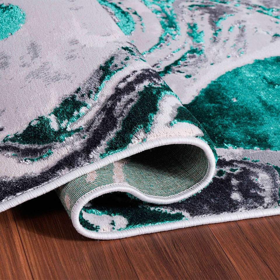 aqua grey abstract rug runner folded on wooden floor