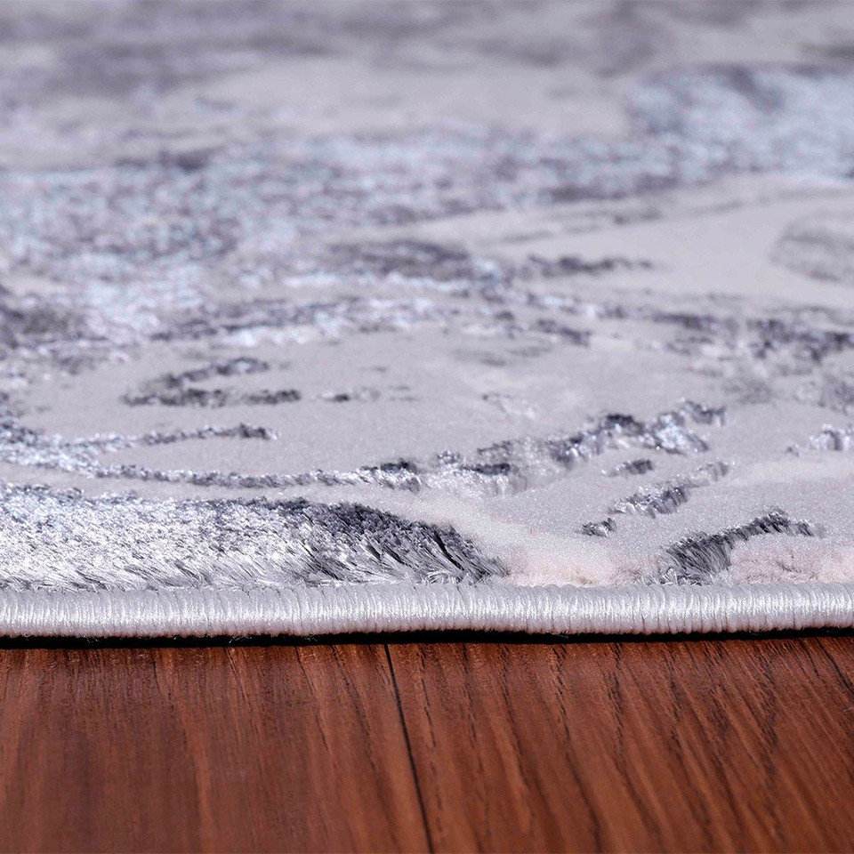silver abstract rug closeup edge on wooden floor