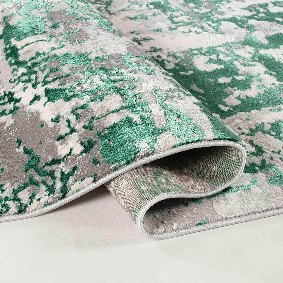 aqua grey abstract rug runner folded on a white floor