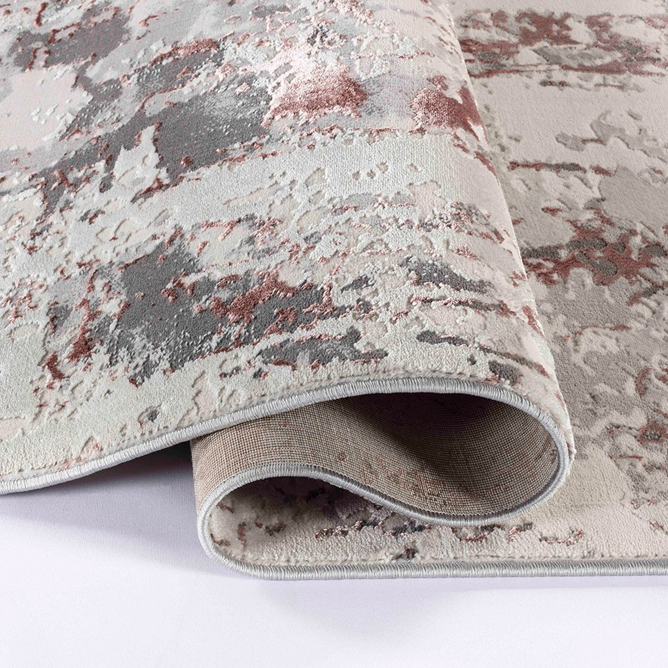 pink grey abstract rug runner folded on a white floor