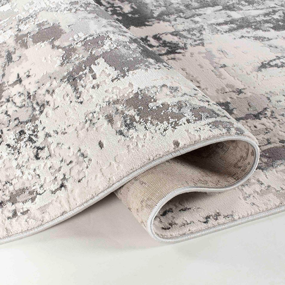 grey abstract rug runner folded on a white floor
