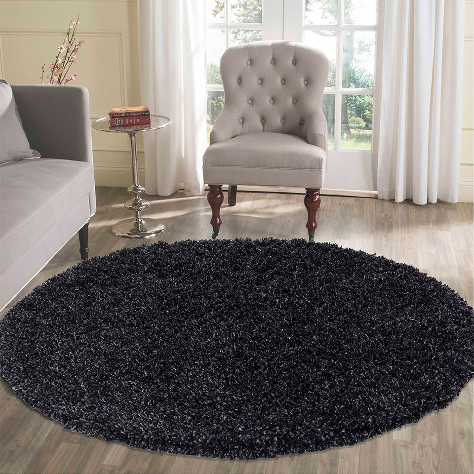 plain shaggy anthracite rug circle in a living room