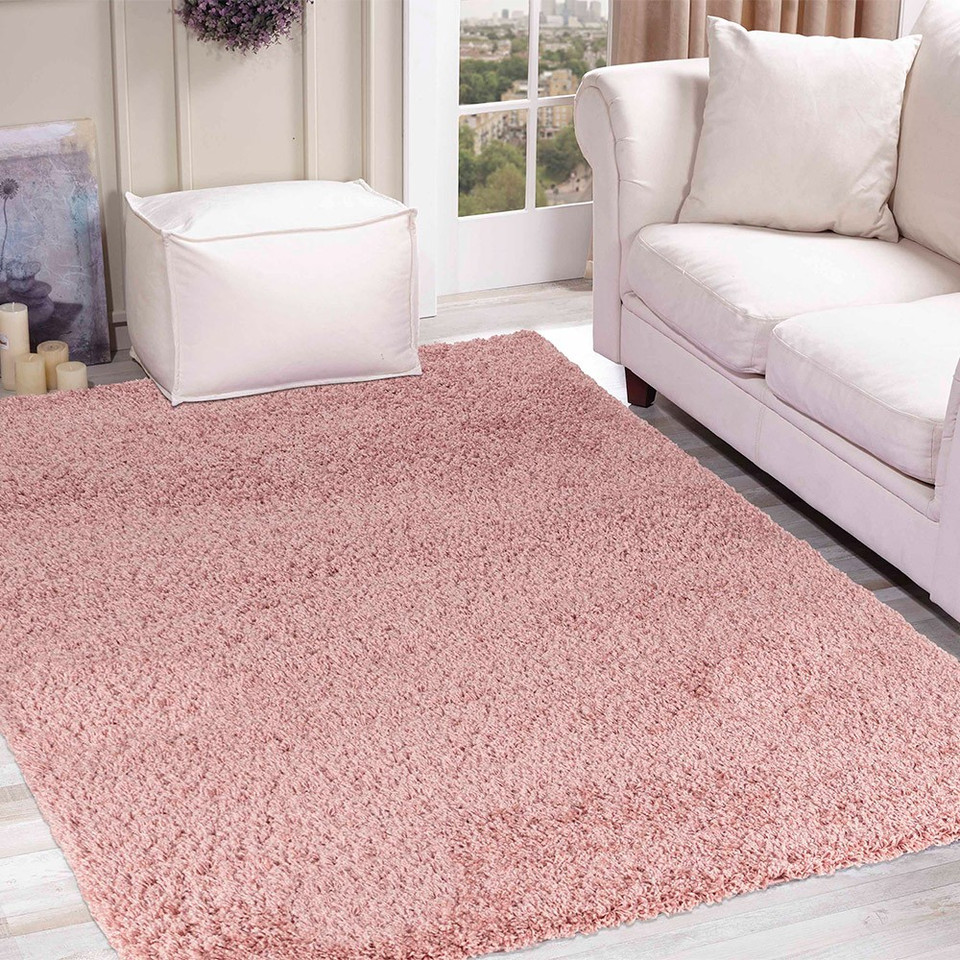 plain shaggy baby pink rug in a living room