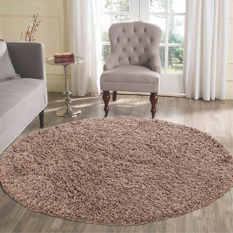 plain shaggy dark beige circle rug in a living room