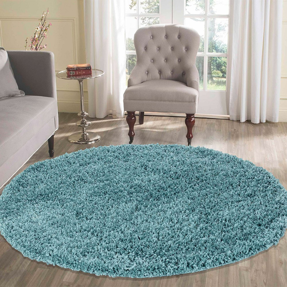 plain shaggy duck egg circle rug in a living room