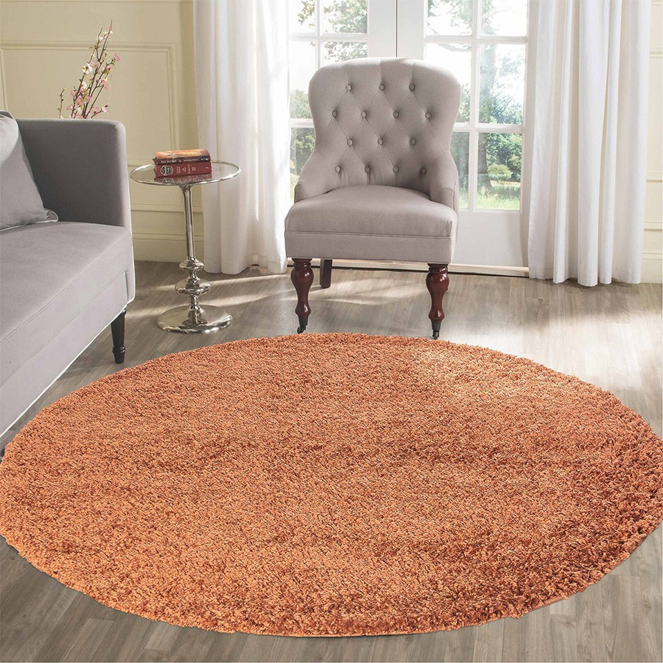 plain shaggy terracotta circle rug in a living room