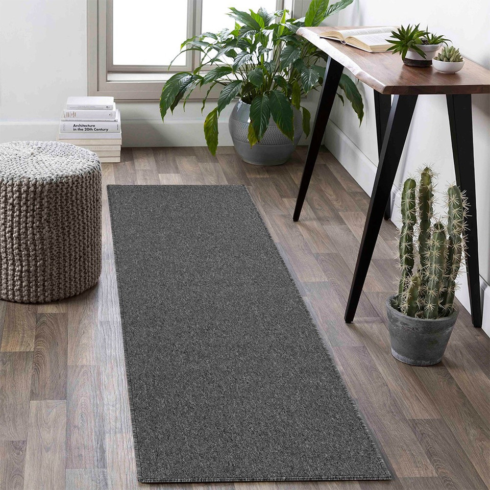 plain low pile dark grey rug runner in a living space