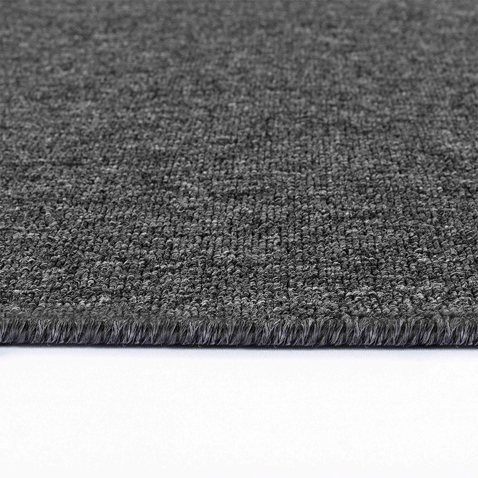 plain low pile dark grey rug runner closeup edge on white floor