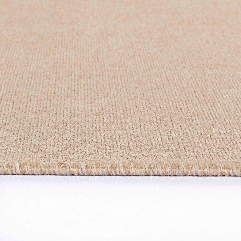 plain low pile light beige rug runner closeup edge on white floor