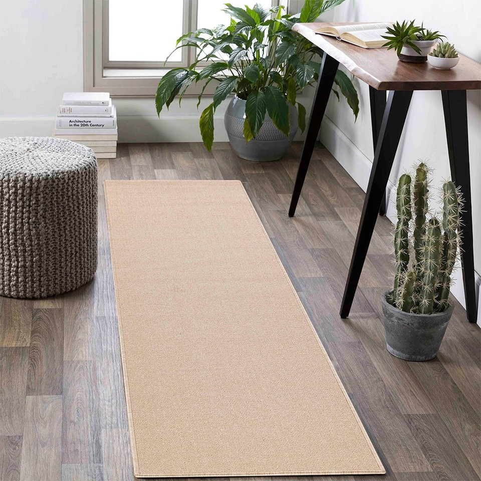 plain low pile light beige rug runner in a living space