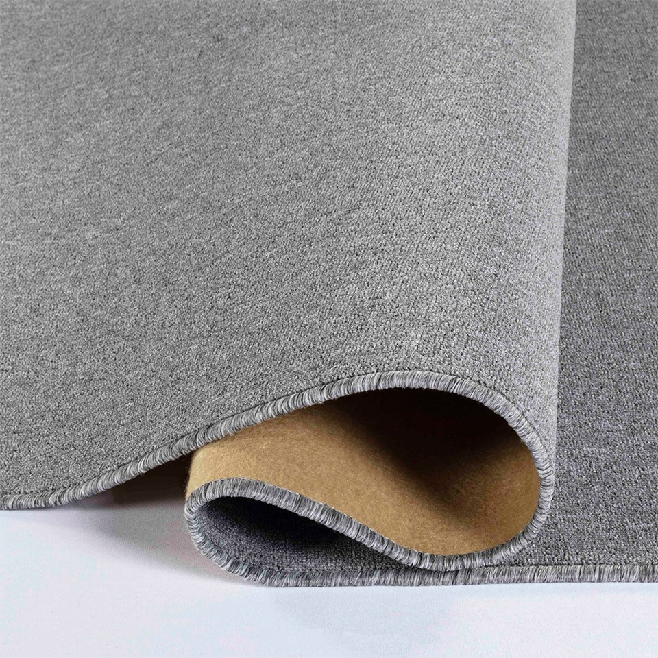 plain low pile silver rug runner folded on white floor